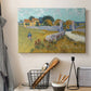 Canvas art print detailing a landscape centered on structure within bright field, displayed in a softly lit workspace setting