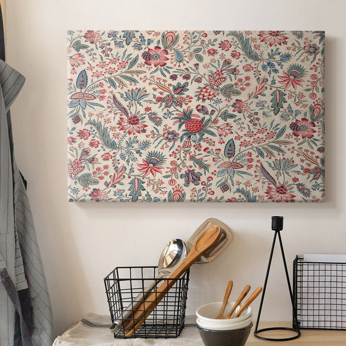 Canvas art print detailing a textile-style artwork with repeating botanical motifs, displayed in a softly lit workspace setting
