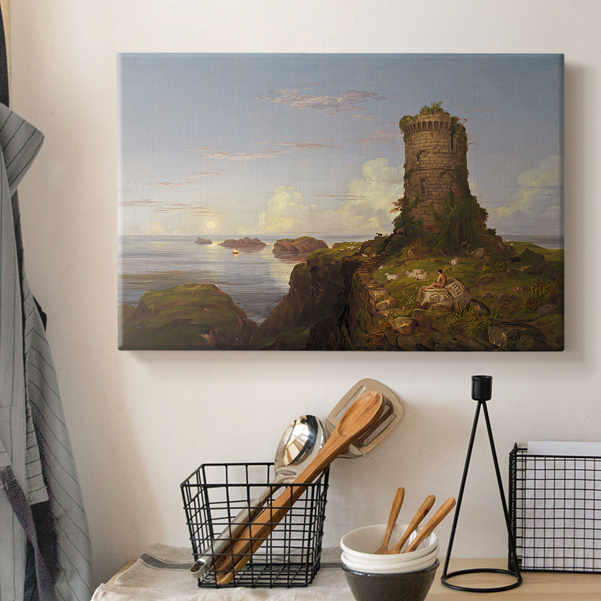 Canvas art print detailing a scenic coastal view, displayed in a softly lit workspace setting