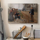 Canvas art print detailing a rustic landscape with figures along open road, displayed in a softly lit workspace setting