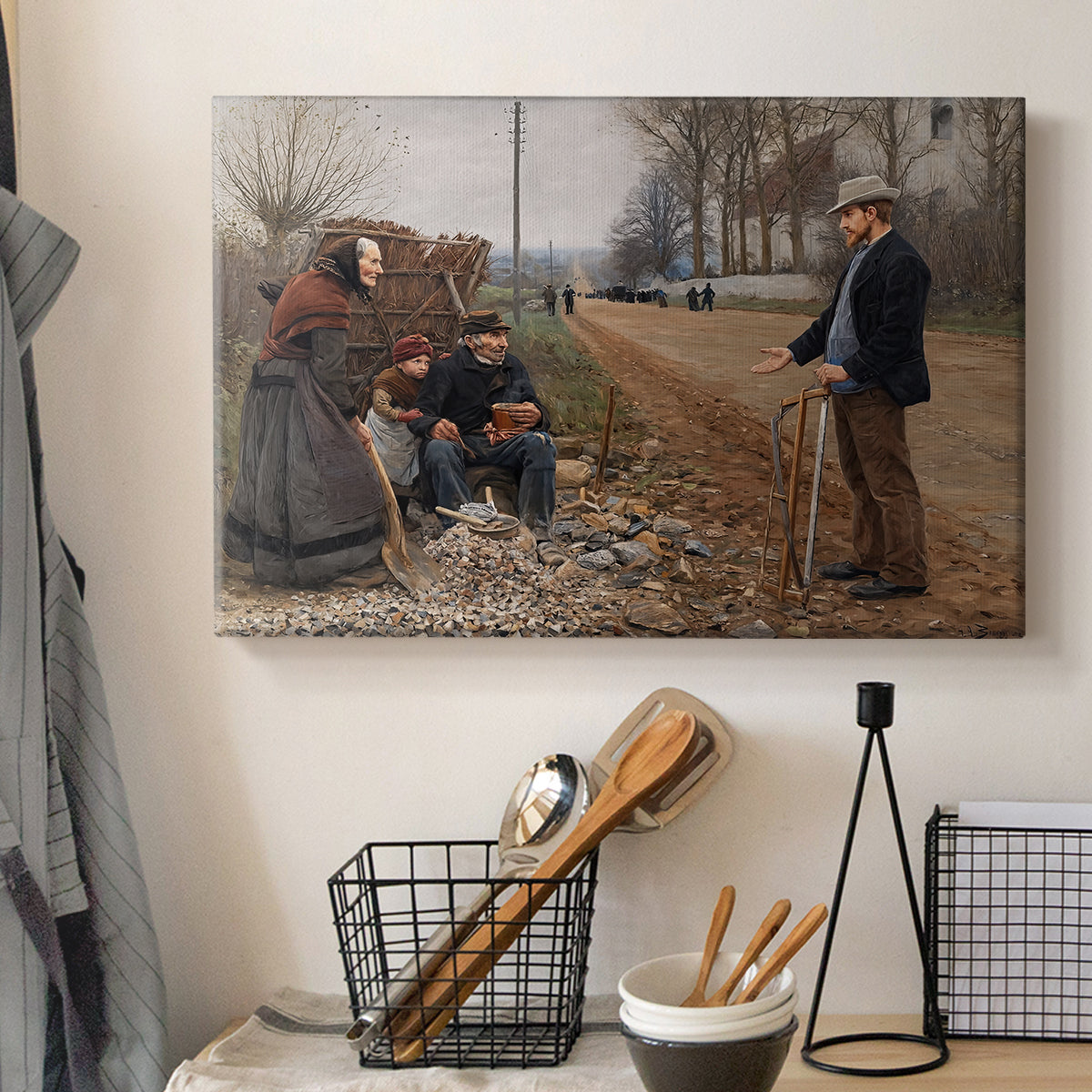 Canvas art print detailing a rustic landscape with figures along open road, displayed in a softly lit workspace setting
