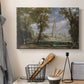 Canvas art print detailing a pastoral setting with cathedral, displayed in a softly lit workspace setting
