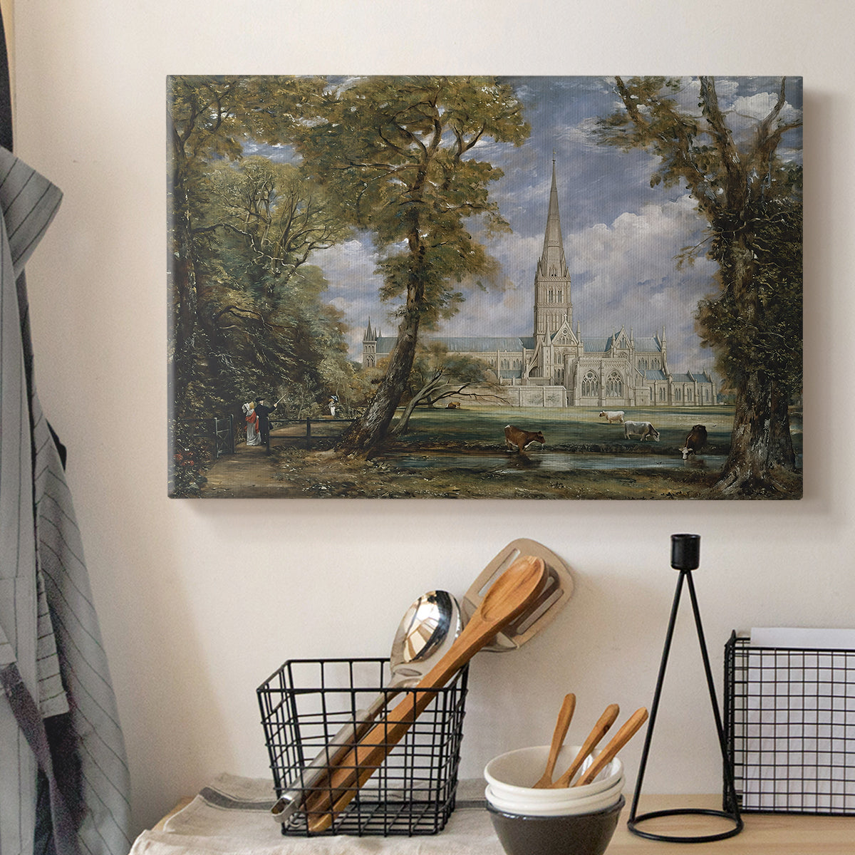 Canvas art print detailing a pastoral setting with cathedral, displayed in a softly lit workspace setting