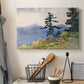 Canvas art print detailing a natural composition with trees and subtle human presence, displayed in a softly lit workspace setting