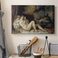 Canvas art print detailing a mythological interior with resting figure and surrounding fabrics, displayed in a softly lit workspace setting