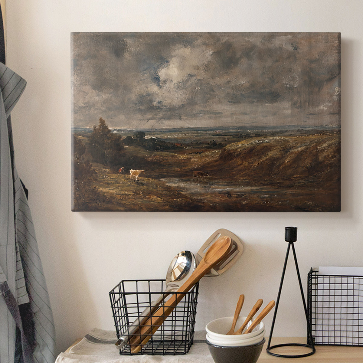 Canvas art print detailing a landscape emphasizing sky and open ground, displayed in a softly lit workspace setting