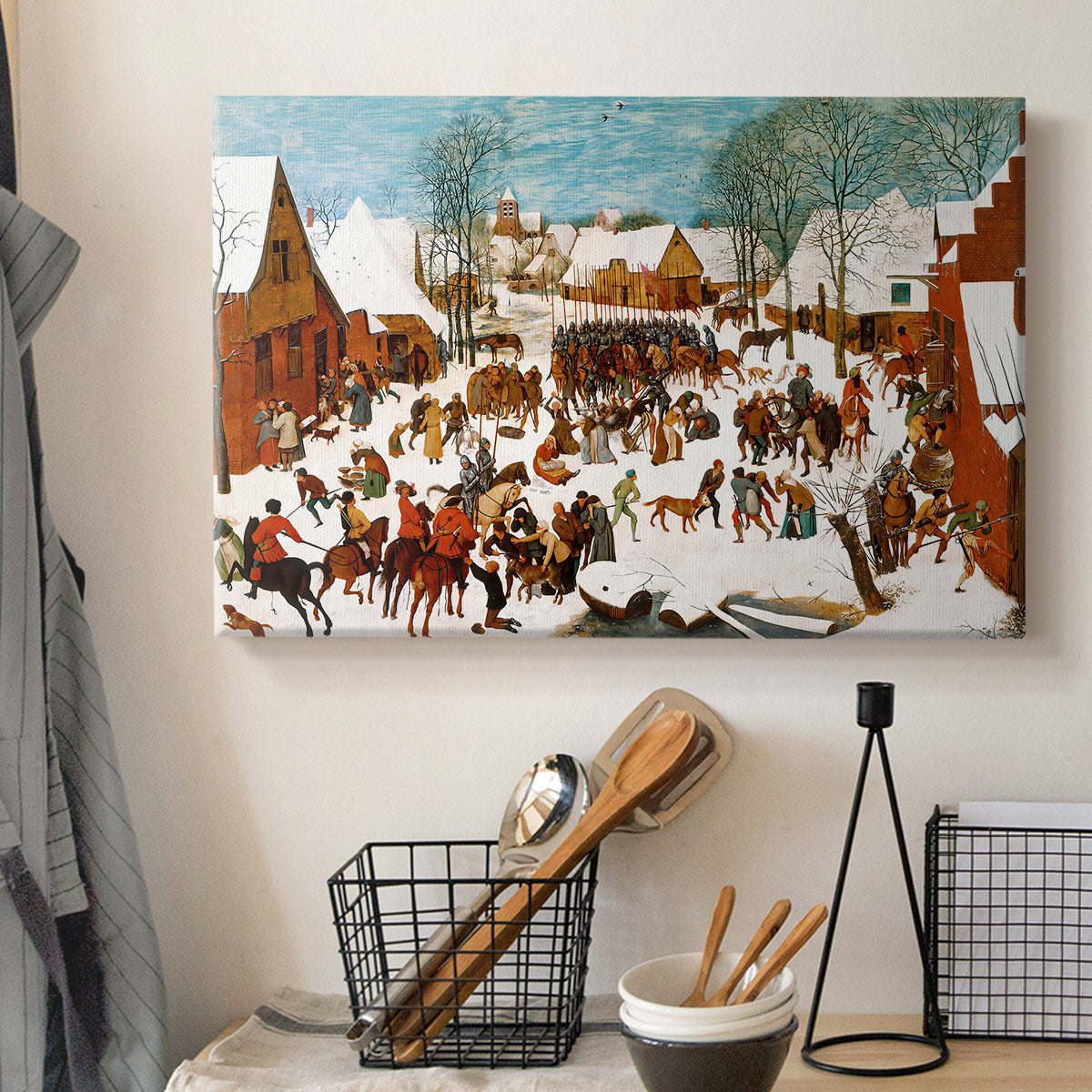 Canvas art print detailing a historical tragedy scene in a village, displayed in a softly lit workspace setting