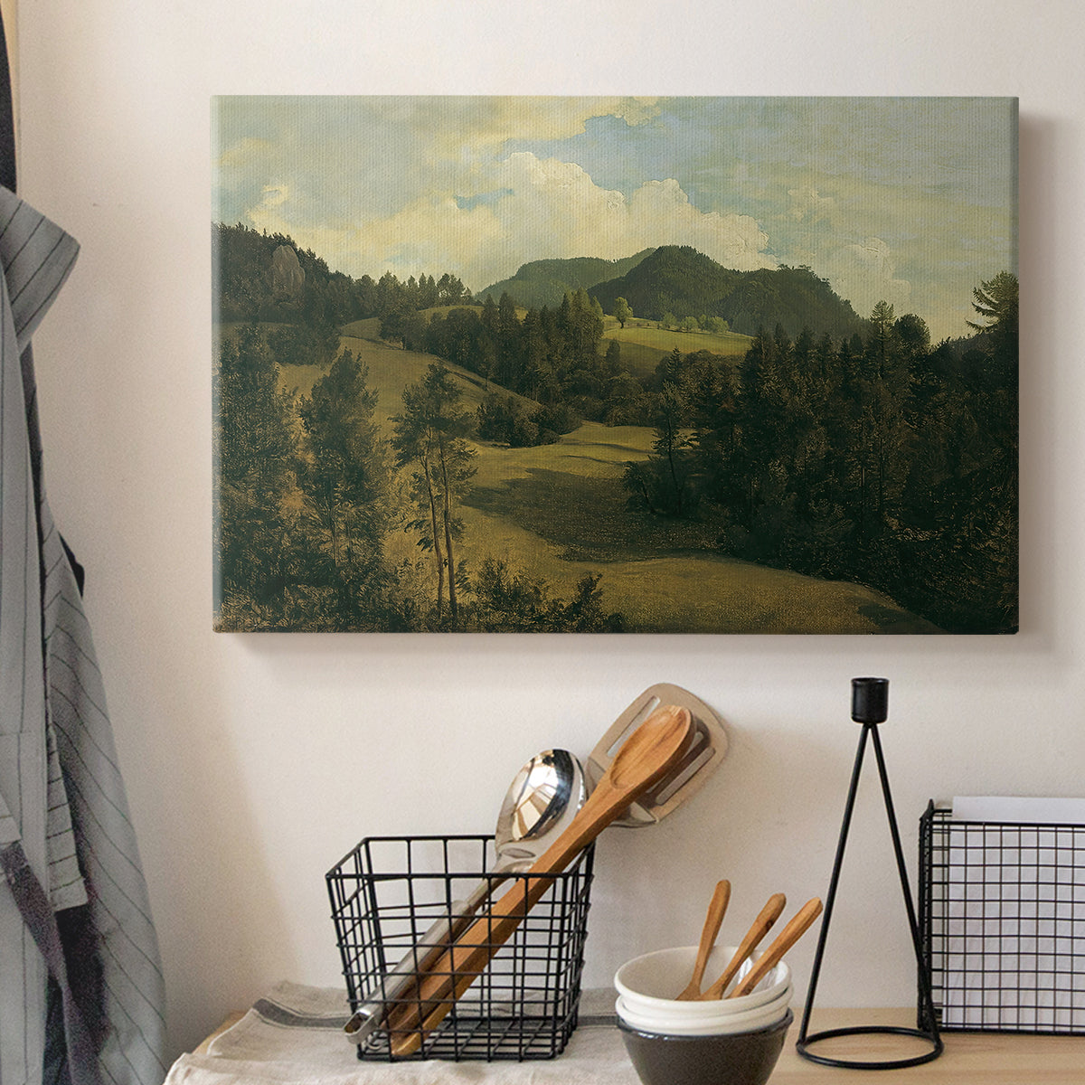 Canvas art print detailing a countryside with open space, displayed in a softly lit workspace setting