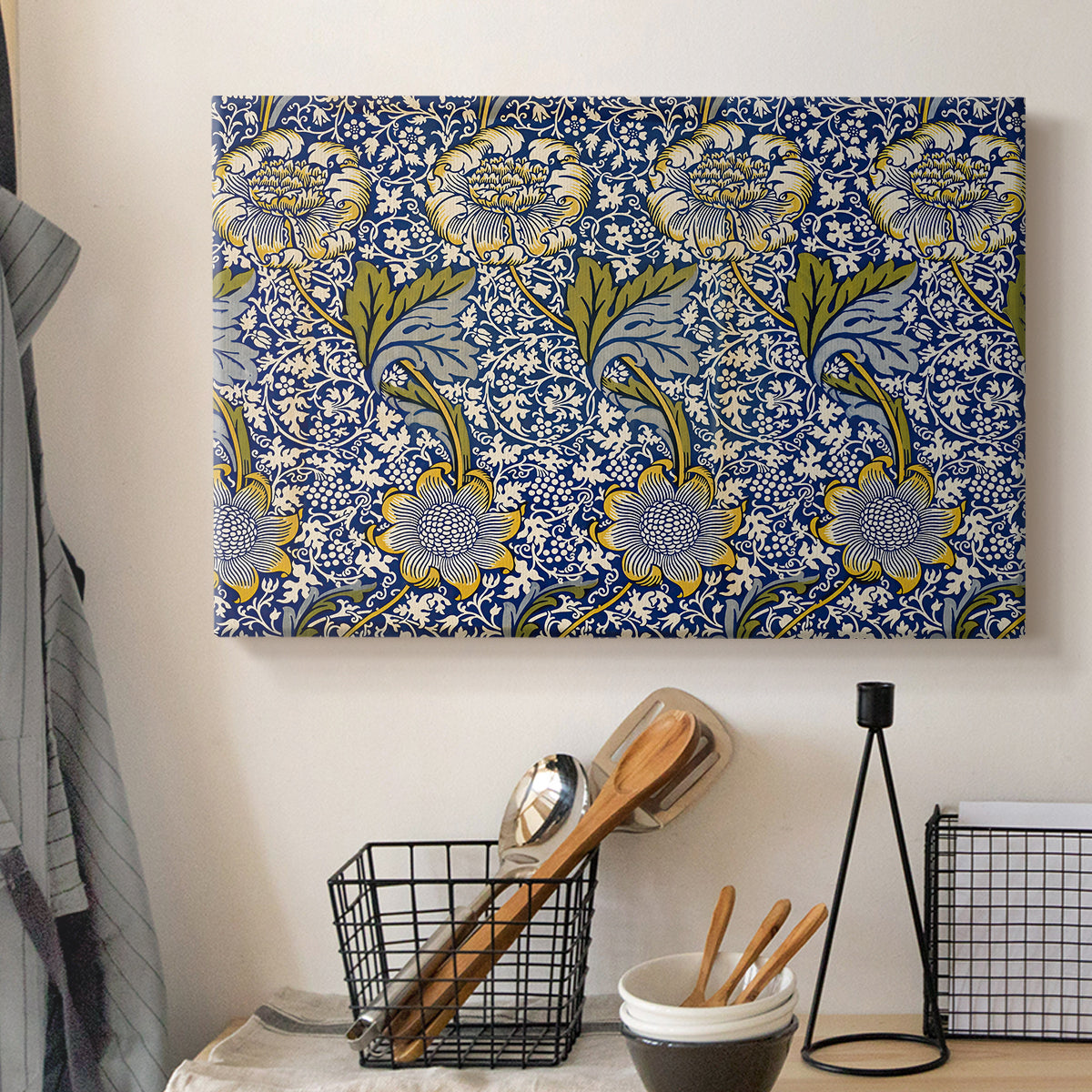 Canvas art print detailing a decorative composition with layered natural motifs and symmetry, displayed in a softly lit workspace setting