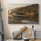 Canvas art print detailing a tranquil harbor landscape with nautical activity, displayed in a softly lit workspace setting