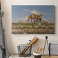 Canvas art print detailing an atmospheric Nile view with figures and shoreline, displayed in a softly lit workspace setting