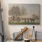 Canvas art print detailing a countryside setting with cows in damp environment, displayed in a softly lit workspace setting