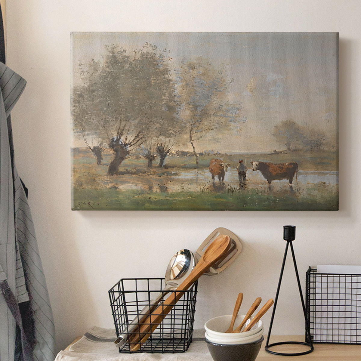 Canvas art print detailing a countryside setting with cows in damp environment, displayed in a softly lit workspace setting