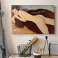 Canvas art print detailing a stylized depiction of woman's back and form in reclining pose, displayed in a softly lit workspace setting