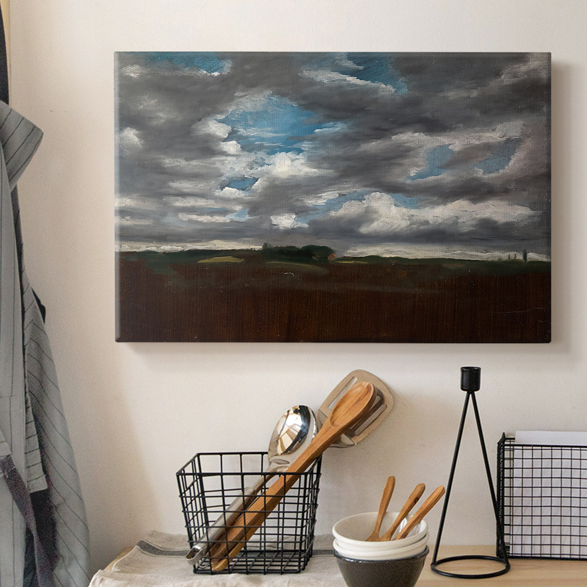 Canvas art print detailing a landscape emphasizing mood, displayed in a softly lit workspace setting