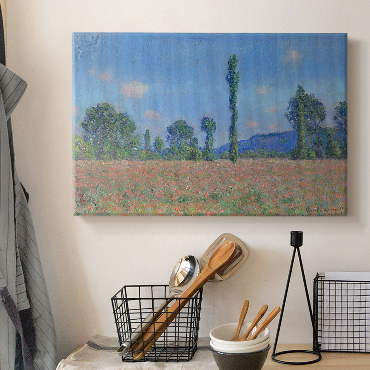 Canvas art print detailing a rural field filled with red blossoms beneath open sky, displayed in a softly lit workspace setting