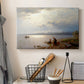 Canvas art print detailing a calm landscape with shoreline activity and soft sky, displayed in a softly lit workspace setting