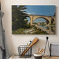 Canvas art print detailing an industrial structure integrated into natural landscape, displayed in a softly lit workspace setting