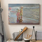 Canvas art print detailing a beach composition with figures and light, displayed in a softly lit workspace setting