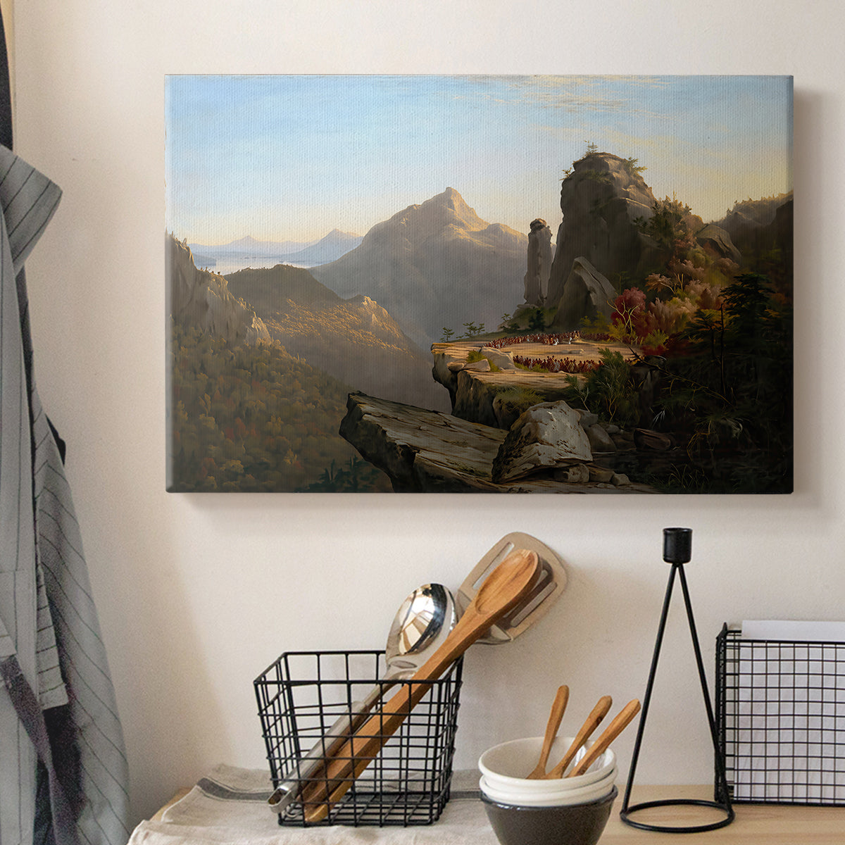 Canvas art print detailing a narrative outdoor scene set in a mountainous river valley, displayed in a softly lit workspace setting