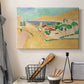 Canvas art print detailing a colorful village scene with water and architecture, displayed in a softly lit workspace setting