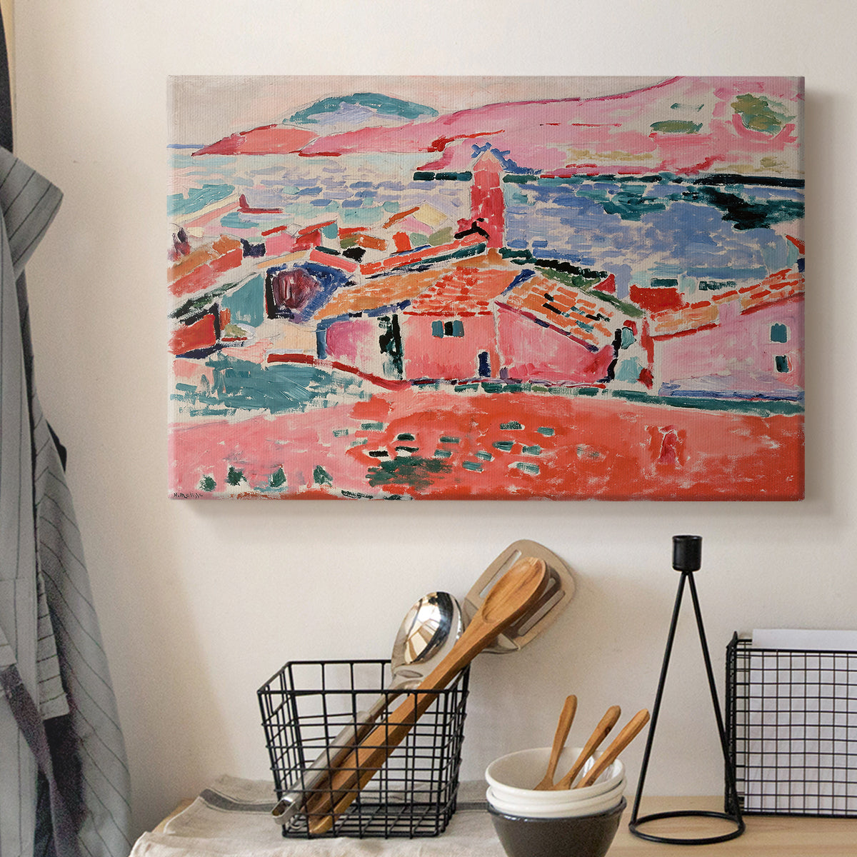 Canvas art print detailing a stylized coastal settlement with architecture and water, displayed in a softly lit workspace setting