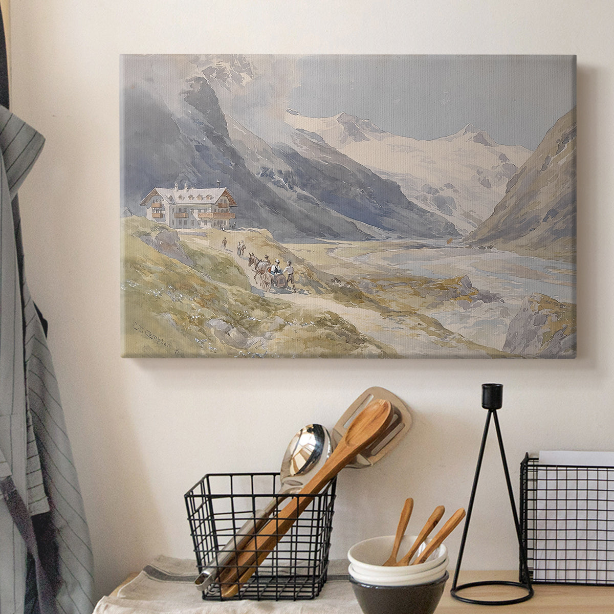 Canvas art print detailing a natural landscape with human presence among mountains, displayed in a softly lit workspace setting