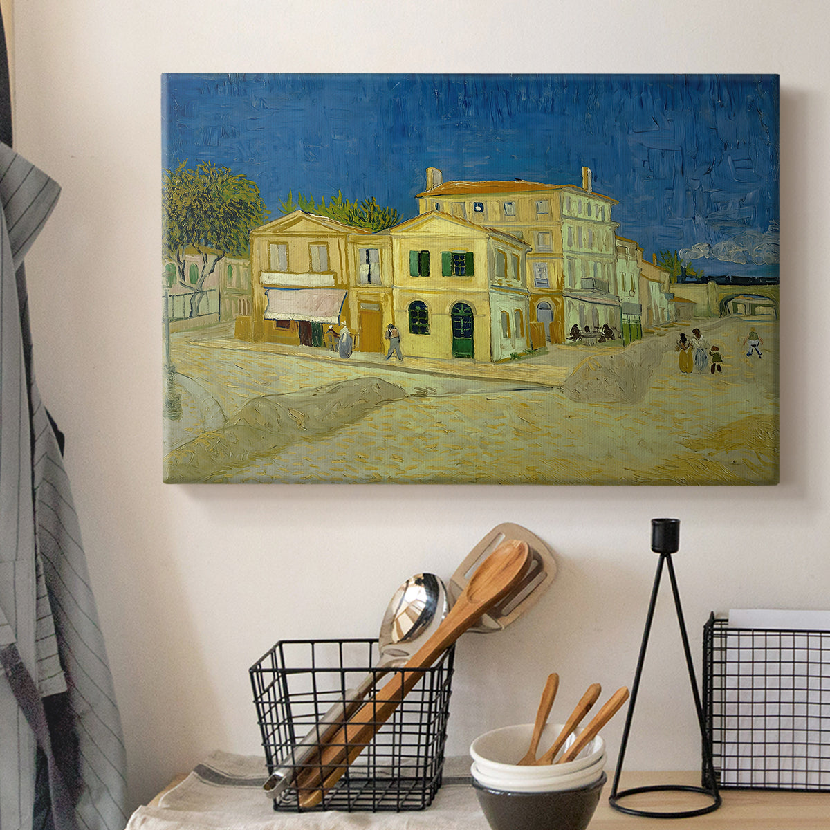 Canvas art print detailing a cityscape centered on structure and surrounding roadway, displayed in a softly lit workspace setting