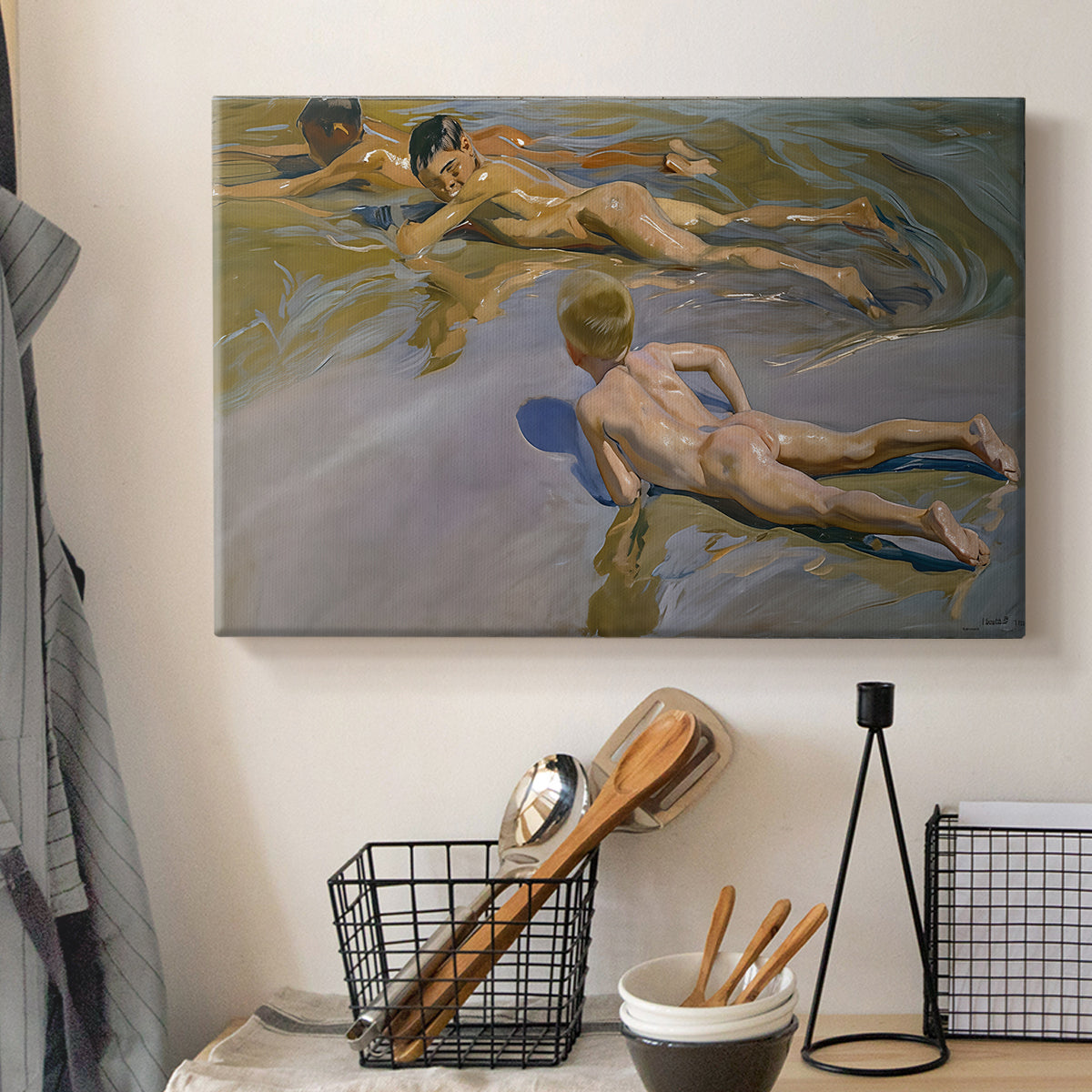 Canvas art print detailing a coastal composition with boys and sand, displayed in a softly lit workspace setting