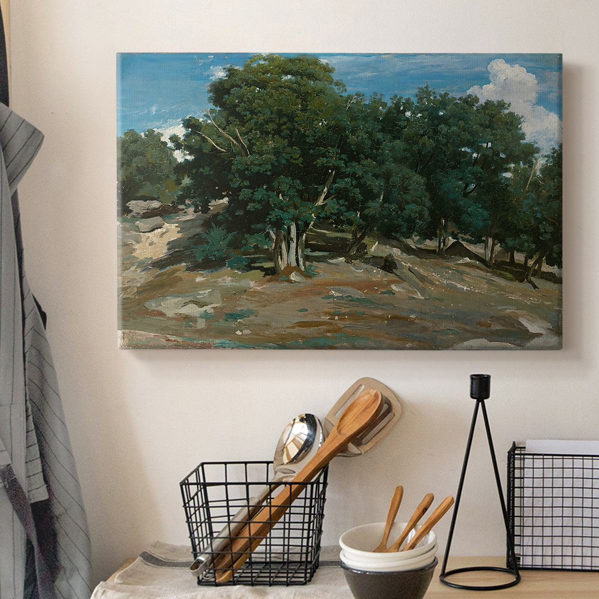 Canvas art print detailing a forest landscape emphasizing trees and space, displayed in a softly lit workspace setting