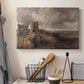 Canvas art print detailing a scenic view combining ruins and water, displayed in a softly lit workspace setting