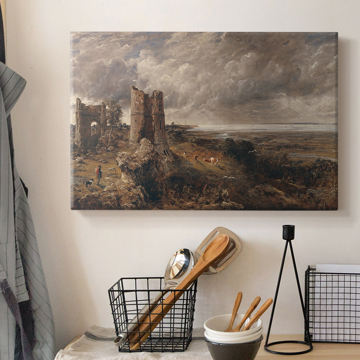 Canvas art print detailing a scenic view combining ruins and water, displayed in a softly lit workspace setting