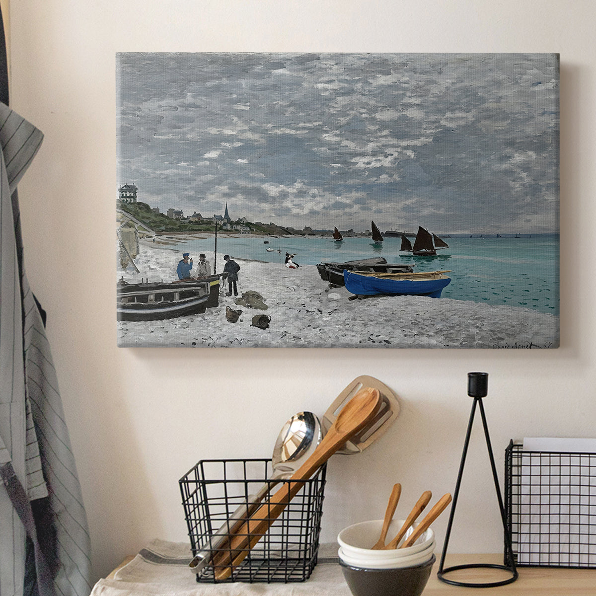Canvas art print detailing an impressionist seaside gathering with flags and ocean view, displayed in a softly lit workspace setting