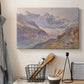 Canvas art print detailing an expansive alpine view with ice and distant mountains, displayed in a softly lit workspace setting