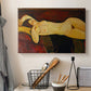 Canvas art print detailing an expressionist depiction of reclining woman with elongated limbs, displayed in a softly lit workspace setting