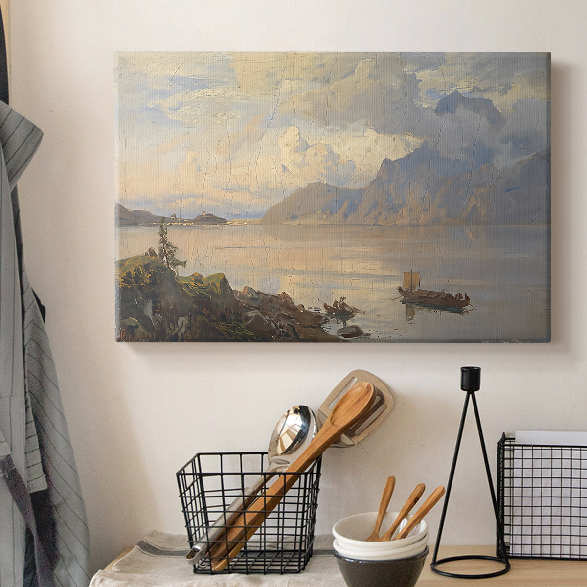 Canvas art print detailing a serene natural setting with water and mountainous backdrop, displayed in a softly lit workspace setting