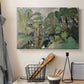 Canvas art print detailing a rustic outdoor view with greenery, displayed in a softly lit workspace setting