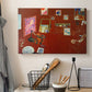 Canvas art print detailing a stylized artist studio dominated by red, displayed in a softly lit workspace setting