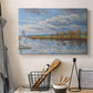 Canvas art print detailing a tranquil composition with riverbank, displayed in a softly lit workspace setting