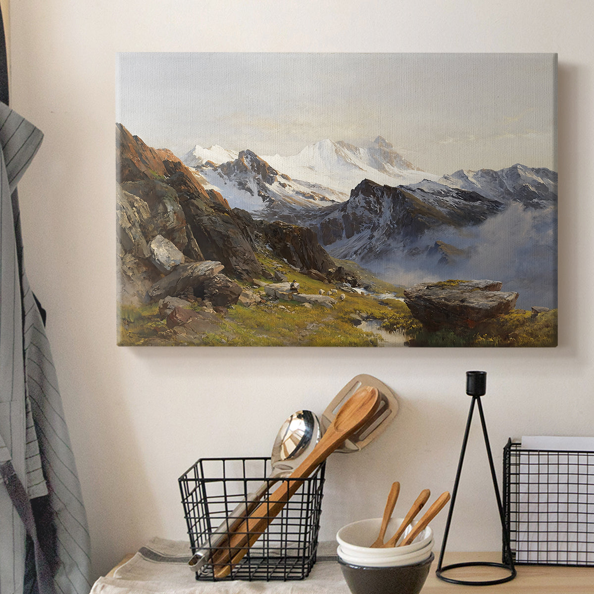 Canvas art print detailing a scenic mountain view with dramatic elevation and depth, displayed in a softly lit workspace setting