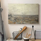 Canvas art print detailing an urban landscape emphasizing depth and arrangement of rooftops, displayed in a softly lit workspace setting