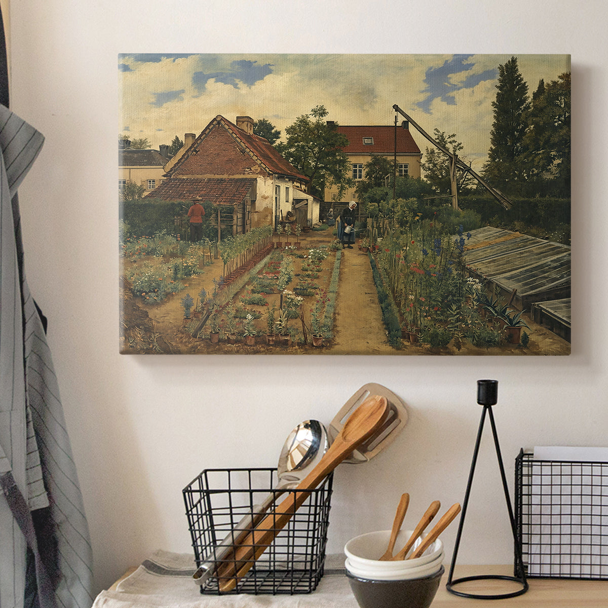 Canvas art print detailing a floral landscape with organized garden elements, displayed in a softly lit workspace setting