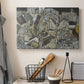 Canvas art print detailing a stylized urban composition with geometric structures and muted tones, displayed in a softly lit workspace setting