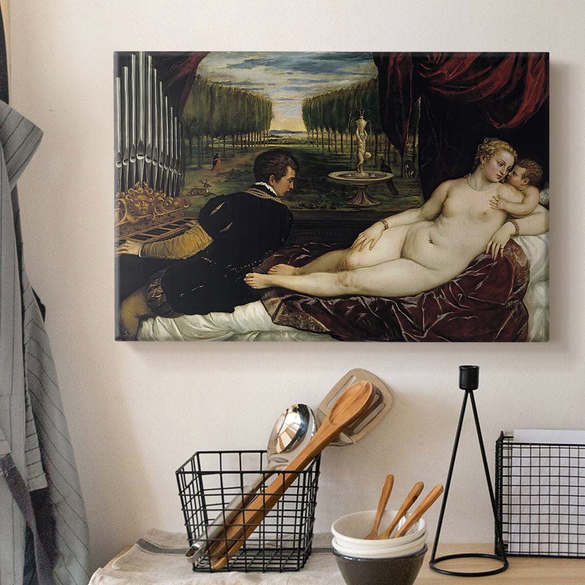 Canvas art print detailing an interior scene with Venus attended by organist and Cupid, displayed in a softly lit workspace setting