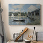 Canvas art print detailing a scenic riverscape with architecture and nautical activity, displayed in a softly lit workspace setting