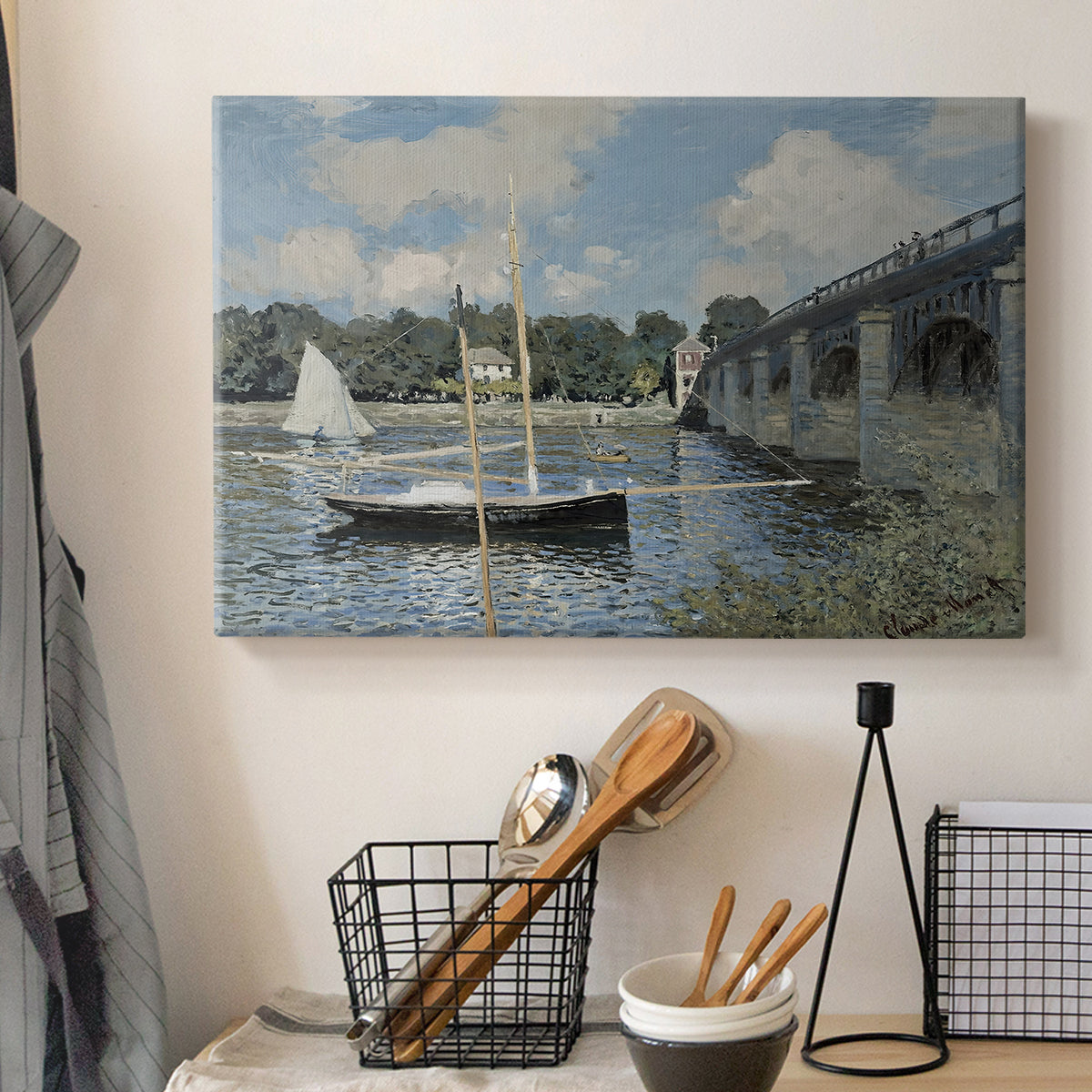 Canvas art print detailing a scenic riverscape with architecture and nautical activity, displayed in a softly lit workspace setting