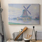 Canvas art print detailing a landscape combining structure and water, displayed in a softly lit workspace setting
