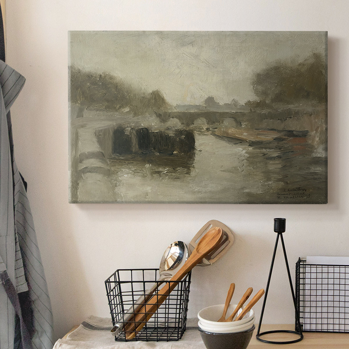Canvas art print detailing an atmospheric landscape featuring a bridge over water, displayed in a softly lit workspace setting
