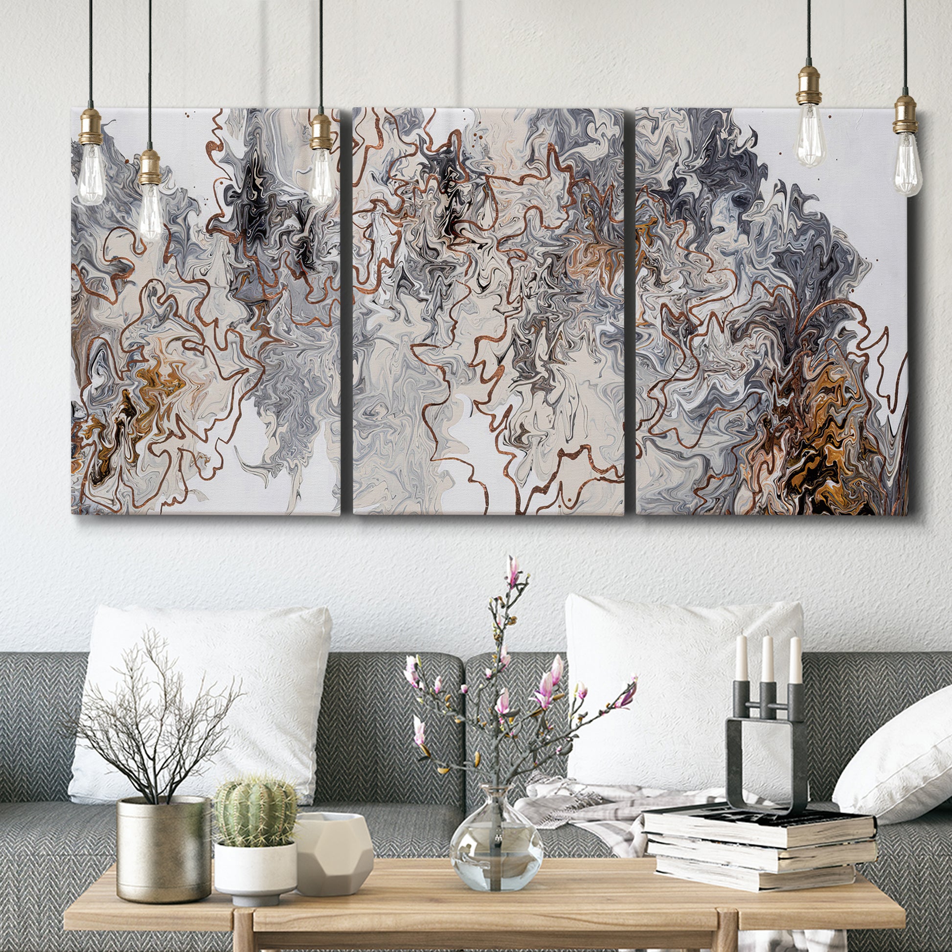 Three-panel canvas wall art featuring wooded trail through forest, displayed in a modern living room above seating.
