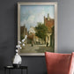 Rustic European street scene painting by Adriaan Eversen in an ornate champagne frame displayed in a dark-toned interior setting.